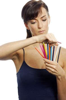 Young woman holding an assortment of colouring pencils