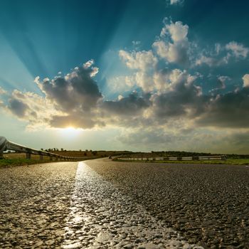 asphalt road close up to sunset