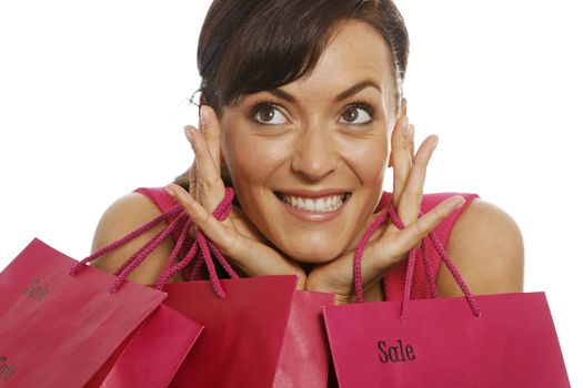 Young woman looking excited with shopping bags