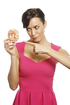 Young woman holding a doughnut looking guilty