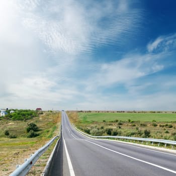 cloudy sky over asphalt road