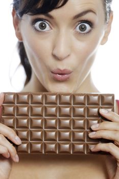 Young woman eating a huge chocolate bar