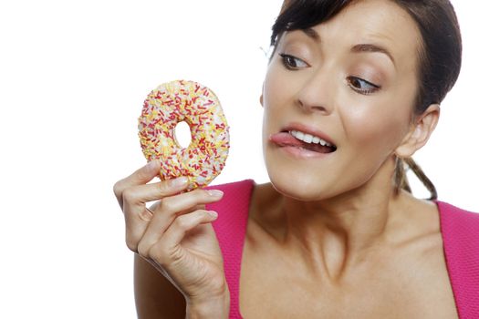 Young woman holding a doughnut looking guilty