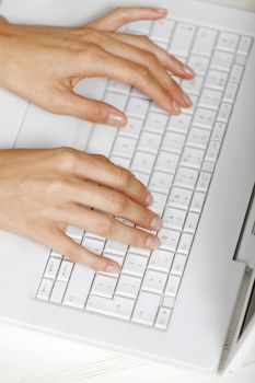 Modern computer keyboard with female hands typing