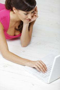 Young woman using a laptop computer at home.