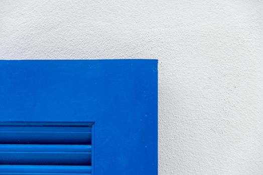 Edge of blue wooden window with white wall3