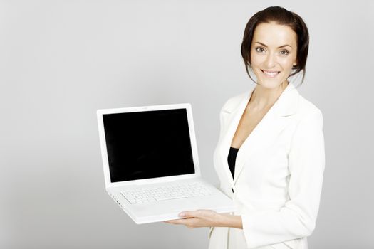 Young business woman demonstrating with a laptop.