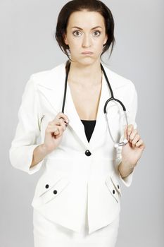 Young female doctor expressing concern and being overworked,