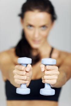 Woman training with dumbbells