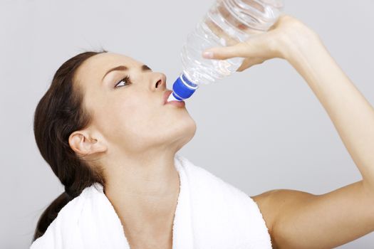 woman with water bottle after fitness training.