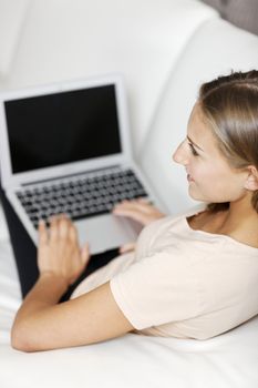 Young woman using her laptop computer at home