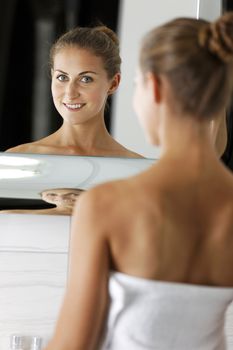 Attractive young woman in her bathroom getting ready.