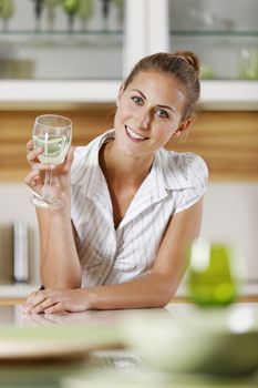 Young business woman relaxing at home with a glass of wine.