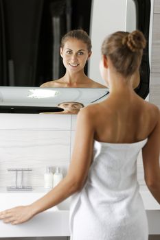 Attractive young woman in her bathroom getting ready.