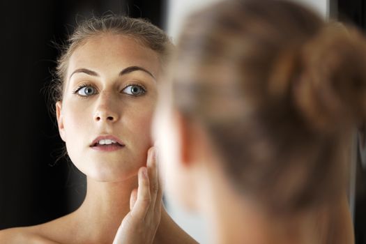 Attractive young woman in her bathroom getting ready.