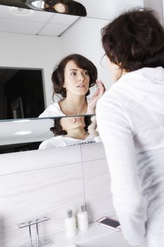 Beautiful young woman getting ready in her bathroom.