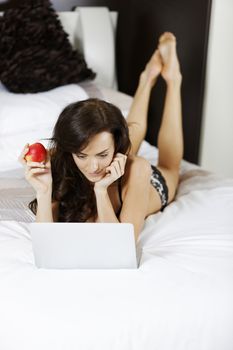 Young woman working from home on her laptop