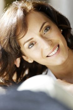 Young woman relaxing on sofa looking out of window.