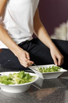 Fresh green salad being prepared in a kitchen