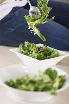 Fresh salad being prepared on kitchen worktop