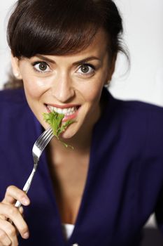 Attractive young woman enjoying a fresh salad.