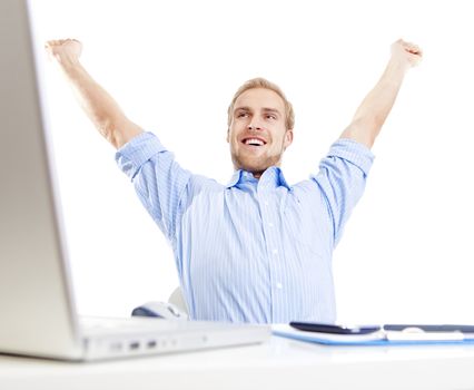 young man at office with his arms outstretched in triumph, smiling