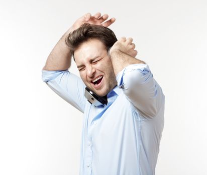 excited man in blue shirt with earphones listening to music