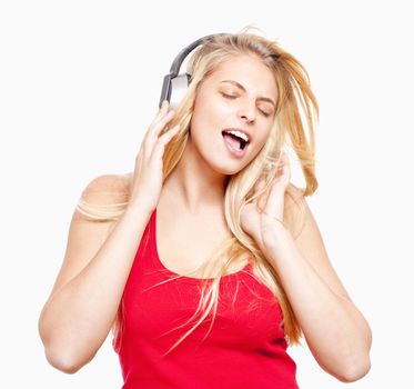 young girl listening to music in headphones - isolated on white