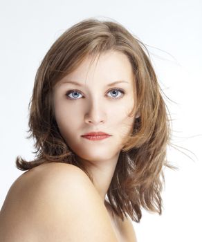 portrait of a young beautiful woman with brown hair against white background