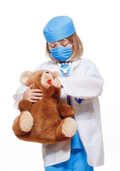 boy with long blond hair playing a doctor