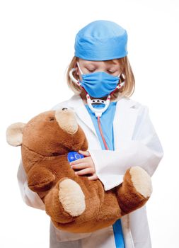 boy with long blond hair playing a doctor