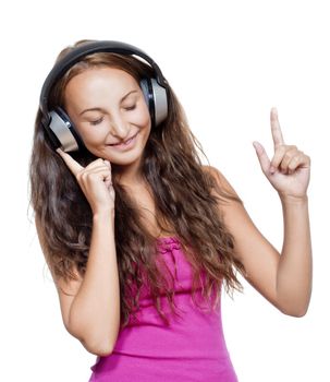 young girl listening to music in earphones smiling - isolated on white