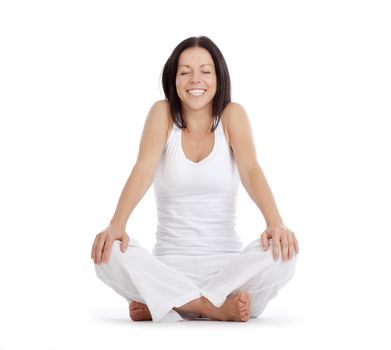 woman sitting on the floor relaxing after exercise smiling - isolated on white