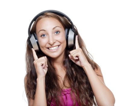 young girl listening to music in earphones smiling - isolated on white