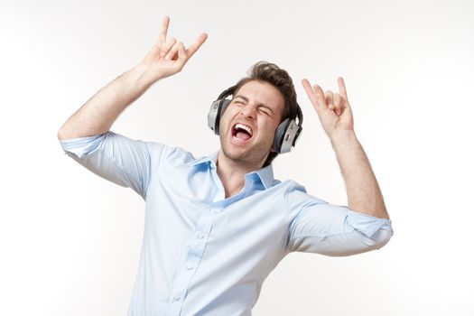 excited man in blue shirt with earphones listening to music