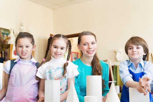 children draw with the teacher in the classroom drawing