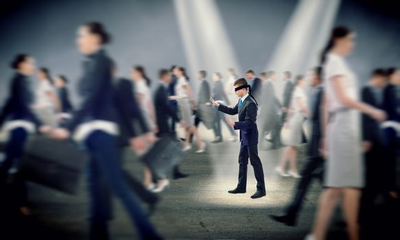 young blindfolded man. his arms and looking for a way out