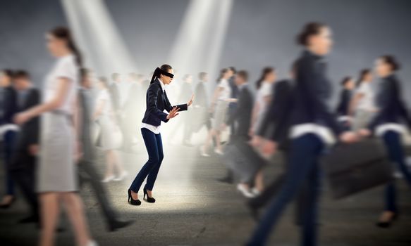 young blindfolded woman. seeking a way out in a crowd