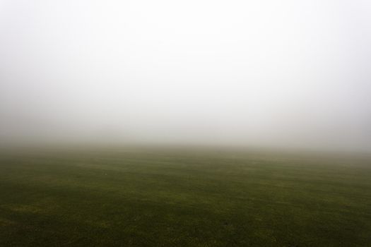 Sports field covered in mist with season weather