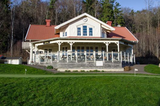 Golf the clubhouse in the woods on a sunny autumn day