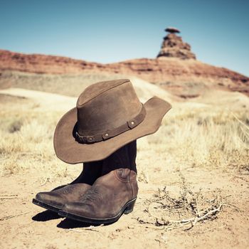 boots and hat in front of famous Mexican hat, USA