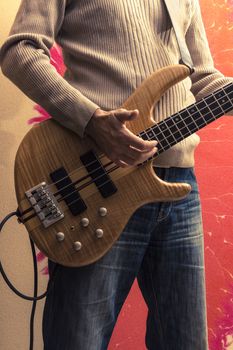 Young Man playing a bass guitar (Series with the same model available.)