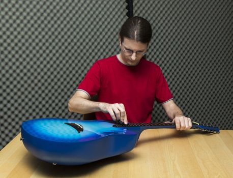 Guitarist cleaning his guitar with a towel ( Series with the same model available)