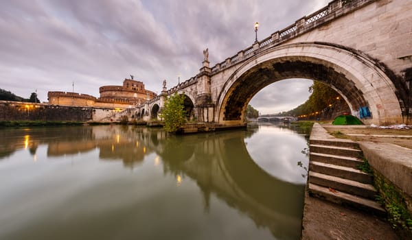 Panorama of Holy Angel Castle and Holy Angel Bridge over the Tiber River in Rome at Dawn, Italy