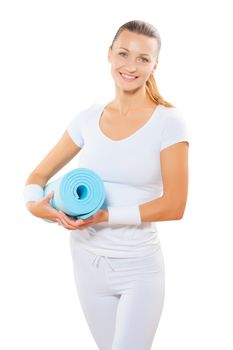 beautiful female wearing  sports clothes holdin blue yoga mat and smiling isolated on white background