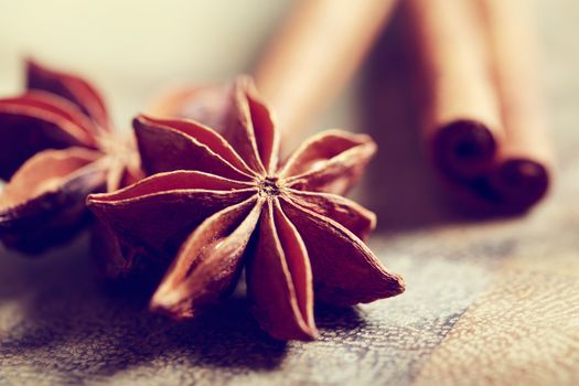 Star anise with cinnamon sticks on rustic wooden table