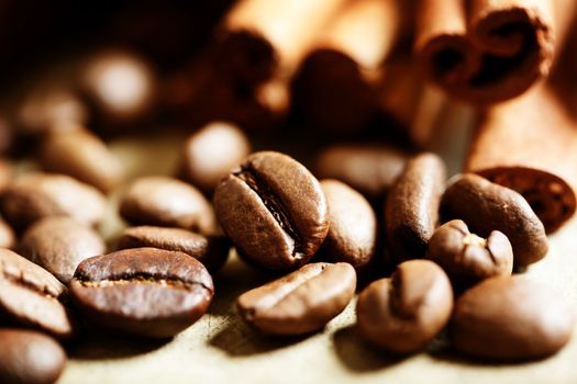 Close up of coffee beans with cinnamon sticks