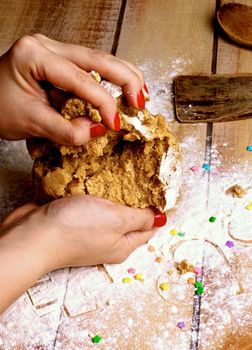 Hands of Women with Red Manicure Making Gingerbread Dough with Flour, Kitchen Utensils and Sweet Decoration on Wooden background