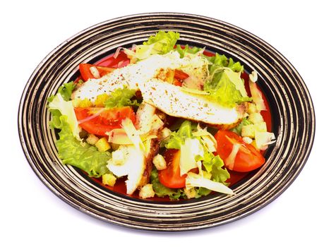Caesar Salad with Grilled Chicken Breast, Garlic Crouton, Lettuce, Tomatoes and Grated Parmesan Cheese on Striped Plate isolated on white background
