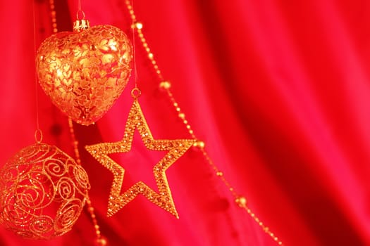 Golden christmas decoration on red fabric background